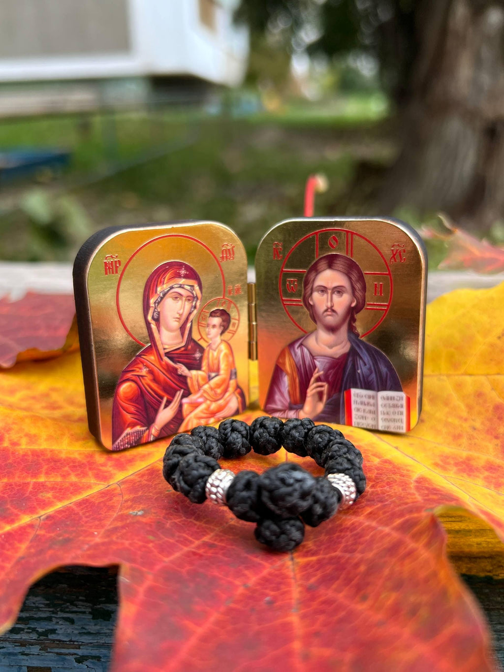 A set of two folding icons 2x1.6 in and a finger rosary. An icon of Jesus Christ and the Mother of God.