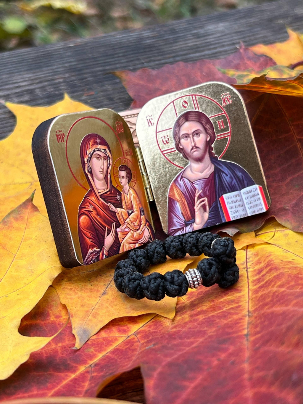 A set of two folding icons 2x1.6 in and a finger rosary. An icon of Jesus Christ and the Mother of God.