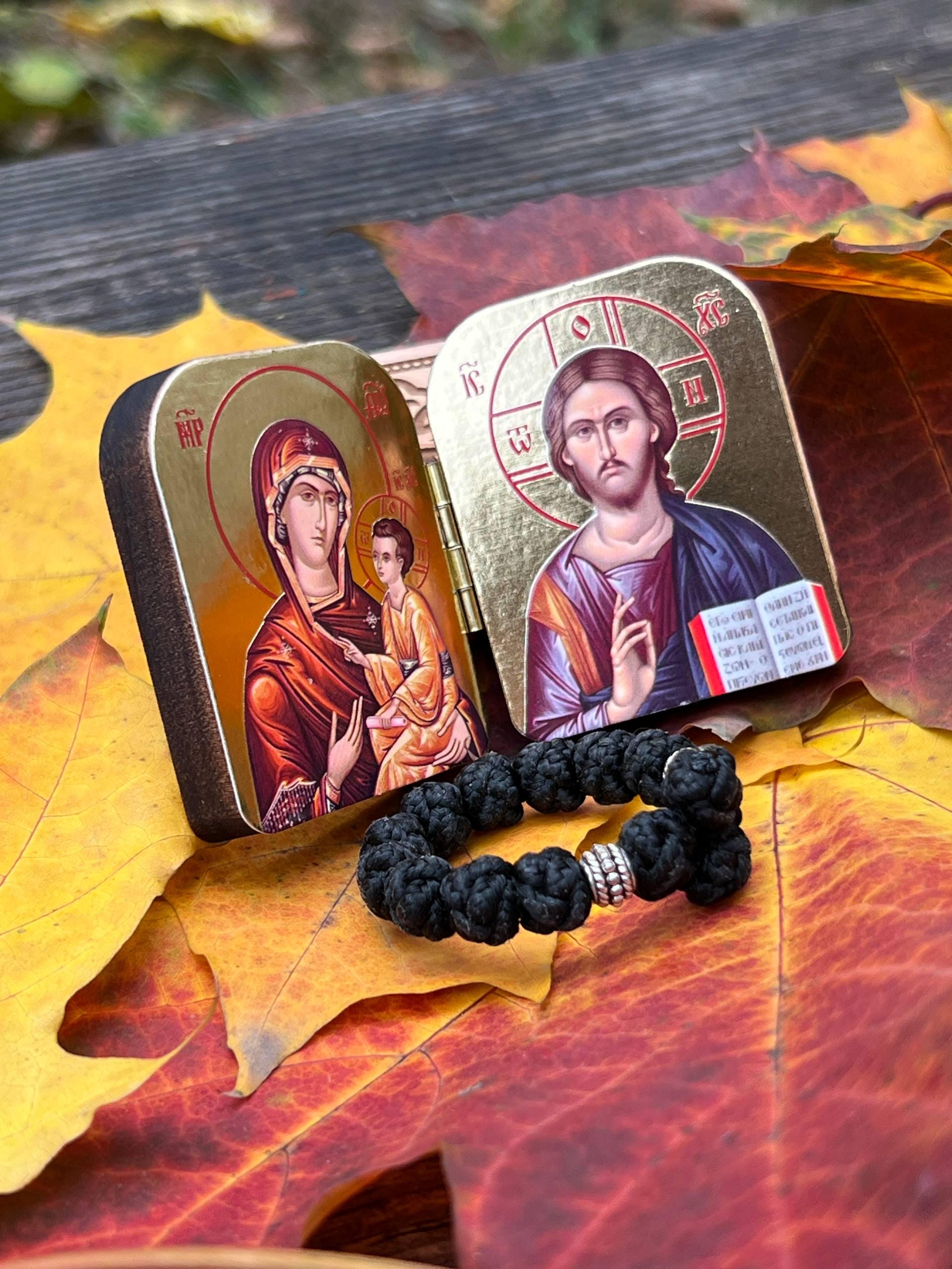 A set of two folding icons 2x1.6 in and a finger rosary. An icon of Jesus Christ and the Mother of God.