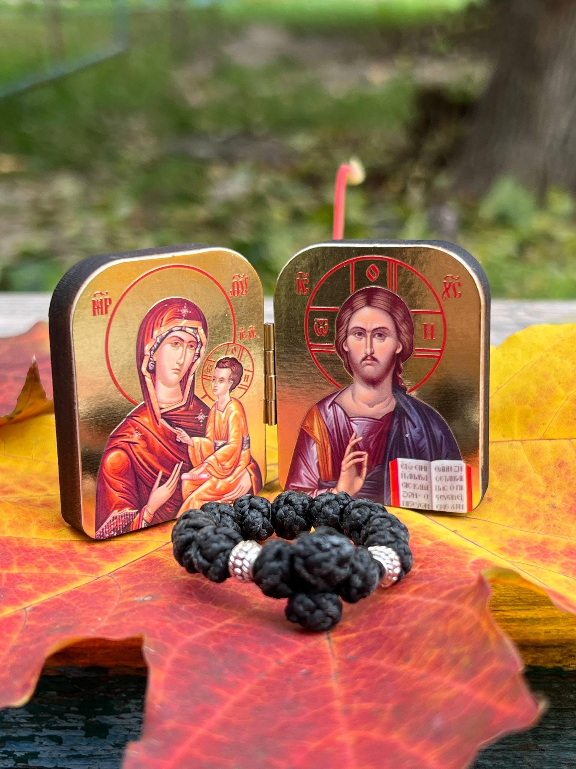 A set of two folding icons 2x1.6 in and a finger rosary. An icon of Jesus Christ and the Mother of God.