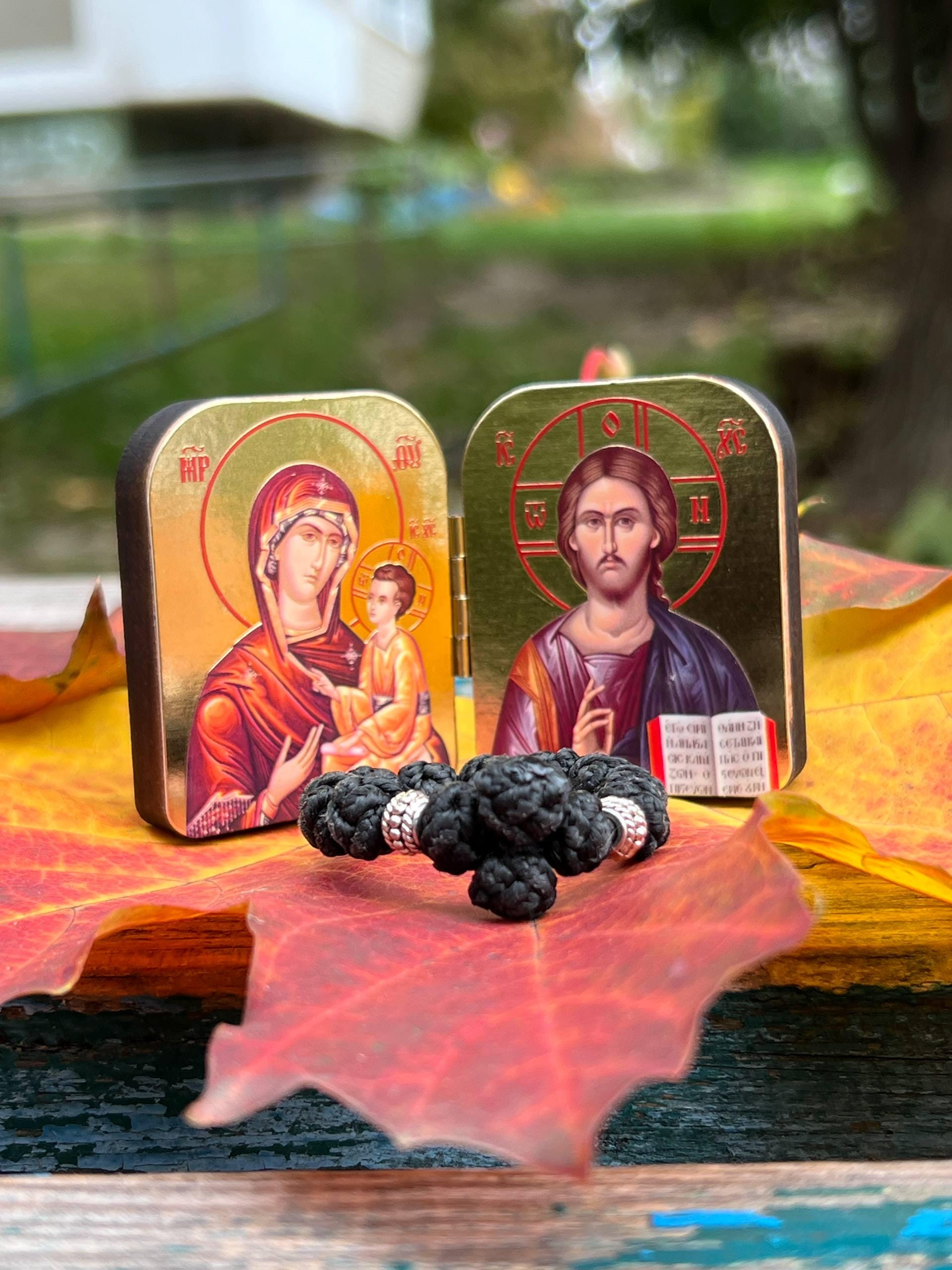 A set of two folding icons 2x1.6 in and a finger rosary. An icon of Jesus Christ and the Mother of God.